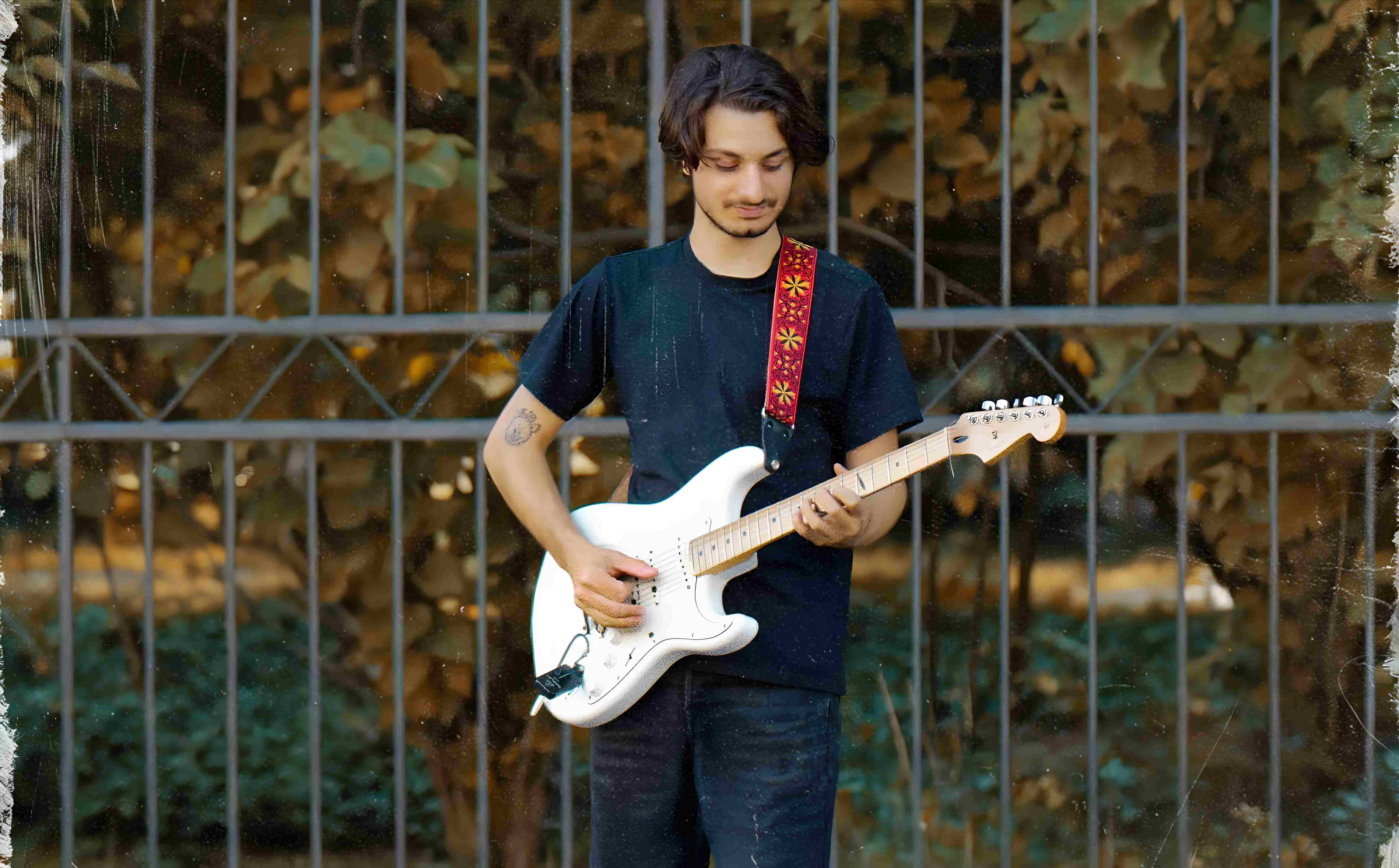 A musician playing guitar on a city street